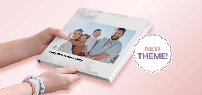 Open layflat photobook showing a photo of a couple on a mountain that stretches across the entire book.