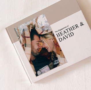 Open book showing photos of mom, dad and daughter outside.