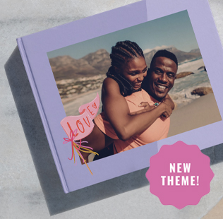 Open book showing photos of mom, dad and daughter outside.