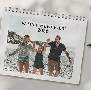 Open book showing photos of mom, dad and daughter outside.