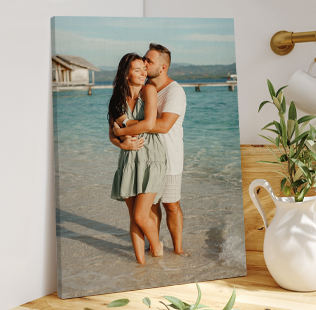 Canvas Print of a man and woman standing in the ocean.