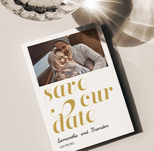 Save the date greeting card showing photo of young couple kissing at the beach.