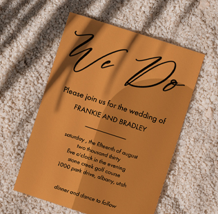 Save the date greeting card showing photo of young couple kissing at the beach.