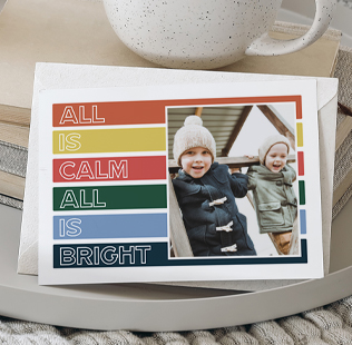 Save the date greeting card showing photo of young couple kissing at the beach.