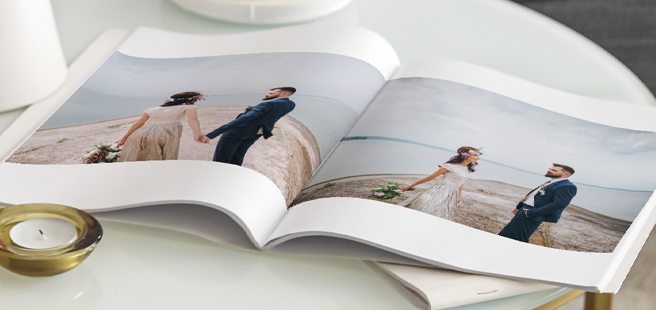 Closed photobook showing photos of a son and father on the cover that reads 'my dad is my superhero'.