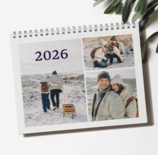 Closed calendar leaned against the wall showing photo of mom and daughter that reads 'Ava & Mom 2024'.