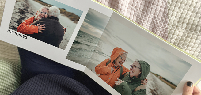 Open layflat photobook showing a photo of a couple on a mountain that stretches across the entire book.