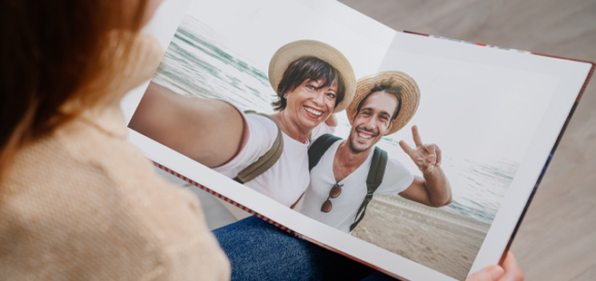 Closed photobook showing photos of a son and father on the cover that reads 'my dad is my superhero'.