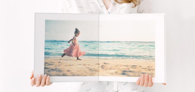 Closed photobook showing photos of a son and father on the cover that reads 'my dad is my superhero'.