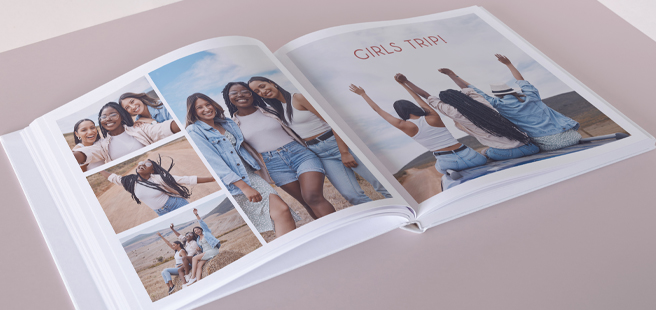 An Open photobook showing photos of friends on a road trip that reads 'Girls Trip!'