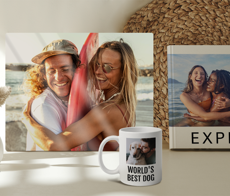 Canvas print of couple hugging with a surfbaord, a white mug with 'World's Best Dog' text and a picture of a person with a dog, half of a photobook of two women hugging
