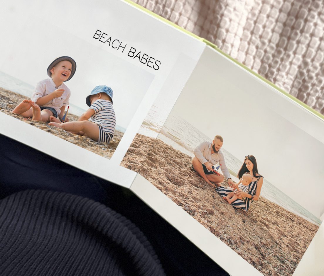 Open layflat photobook with photos of a boho couple for a wedding