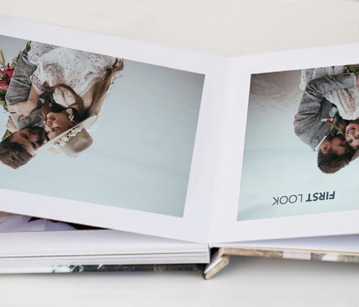 Open layflat photobook with photos of a boho couple for a wedding