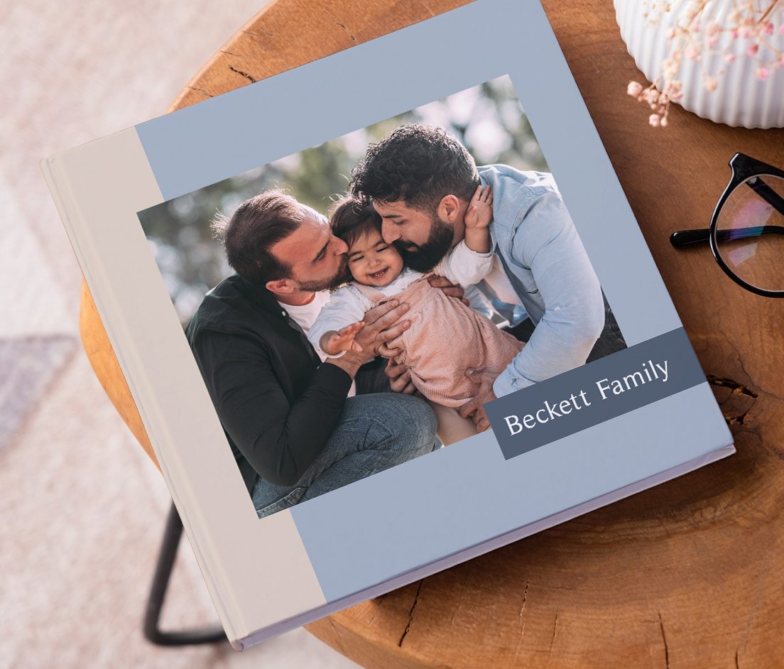 Two photobooks stack on top of each other with a photo of a man looking over the ocean on the front with the text Norway 2024'