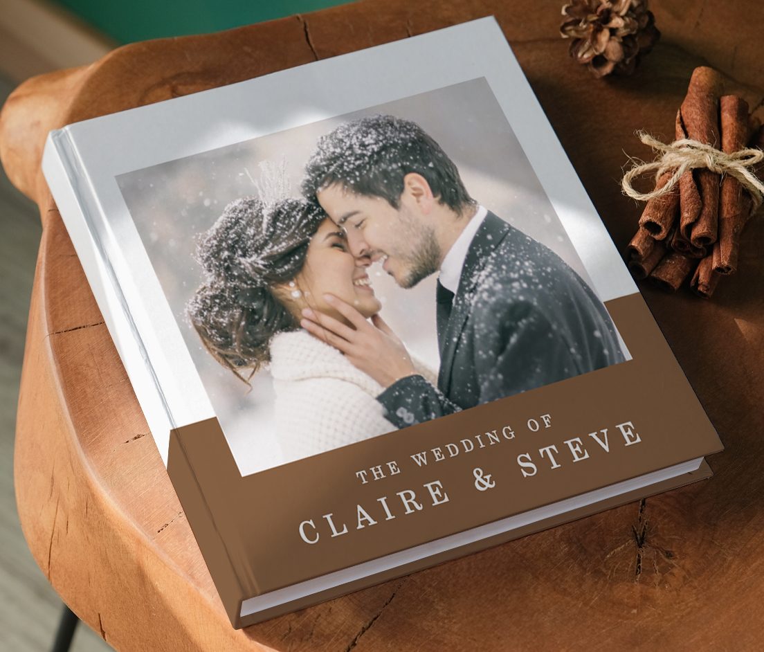 Photobooks Two photobooks stack on top of each other with a photo of a man looking over the ocean on the front with the text Norway 2024'