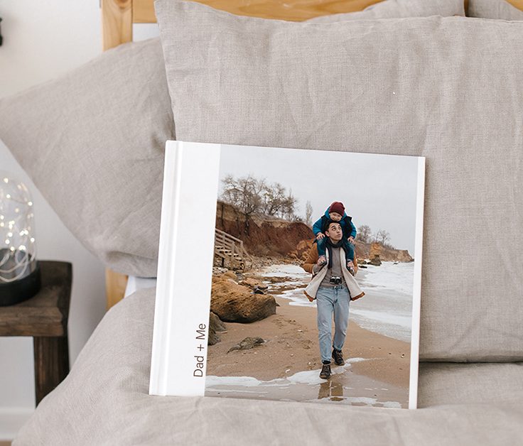 Photobooks Two photobooks stack on top of each other with a photo of a man looking over the ocean on the front with the text Norway 2024'