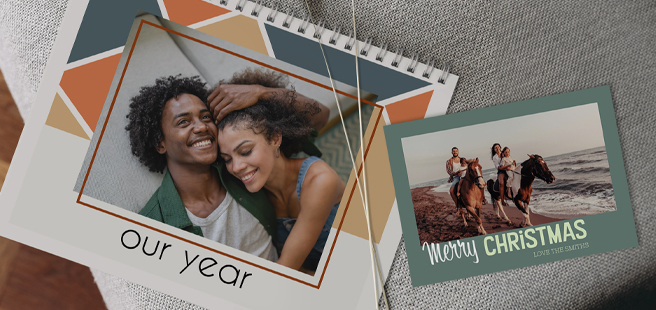 Open layflat photobook showing a photo of a couple on a mountain that stretches across the entire book.