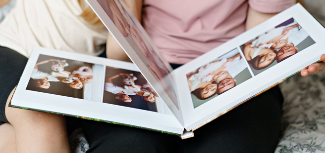 Closed photobook showing photos of a son and father on the cover that reads 'my dad is my superhero'.