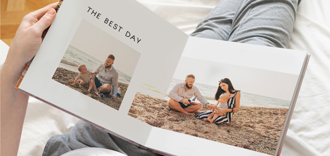 Closed photobook showing photos of a son and father on the cover that reads 'my dad is my superhero'.