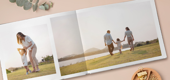 Closed photobook showing photos of a son and father on the cover that reads 'my dad is my superhero'.