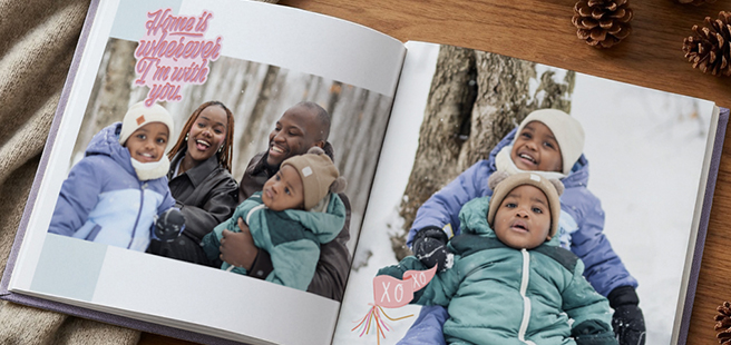 Woman holding an open photobook showing photos of friends celebrating the 4th of July.