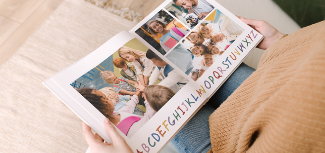 Woman holding an open photobook showing photos of friends celebrating the 4th of July.