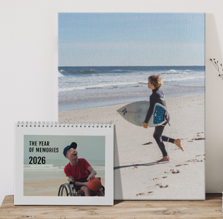 Stack of 3 closed soft photobooks. Top book shows a photo of Mom and son dressed up in costume that reads 'Memories'.