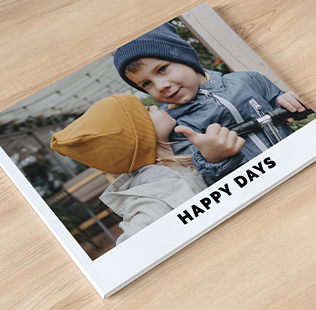 Open book showing photos of mom, dad and daughter outside.