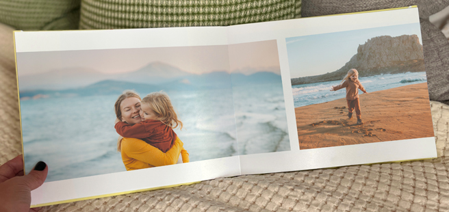 Closed photobook showing photos of a son and father on the cover that reads 'my dad is my superhero'.