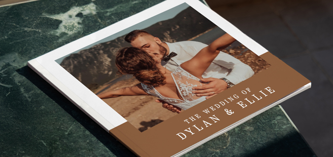 Closed photobook showing photos of a son and father on the cover that reads 'my dad is my superhero'.