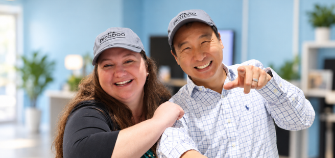 Two Picaboo team members smiling and pointing at the camera