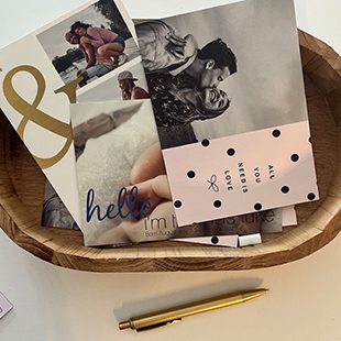 Open calendar hung up on the wall featuring a photo of two children and a dog with the text 'August' underneath