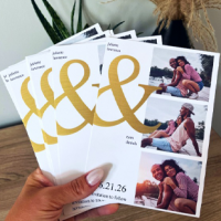A hand holding 4 cards with a large '&' sign and three photos featuring a couple hugging