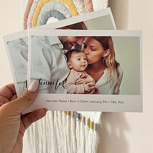 A calendar propped on a white table with a photo of two women hugging in the water with the text on the front 'Wanderlust Adventure Awaits, Go Find It'