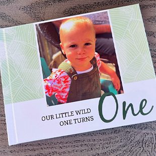 Photobook with a young child on the cover with the text 'Our Little Wild One Turns One'