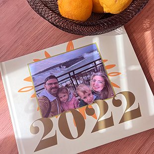 A hand holding 4 cards with a large '&' sign and three photos featuring a couple hugging